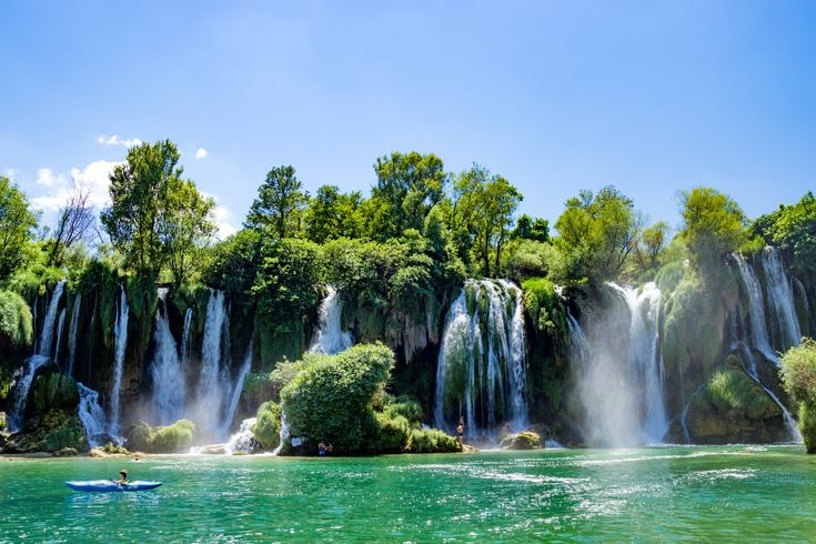Kravica Waterfalls in Bosnia and Herzegovina with turquoise water and green cliffs
