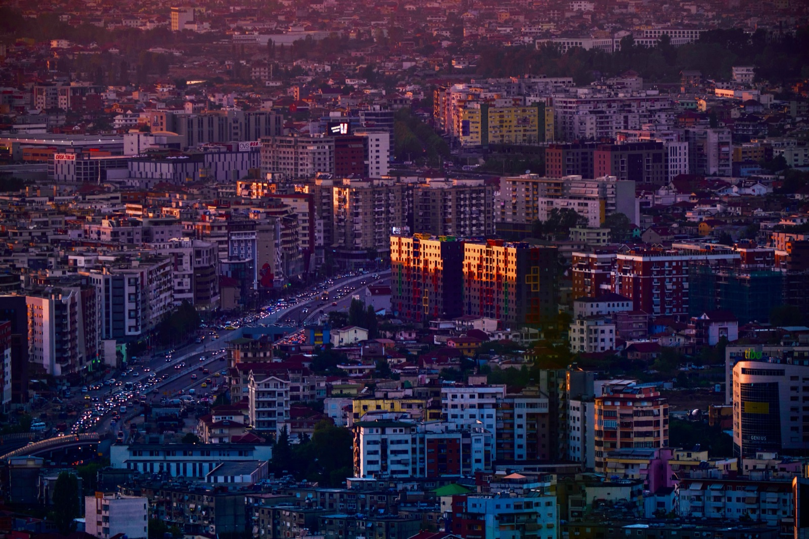 Tirana's apartment blocks and busy streets glowing in the evening light