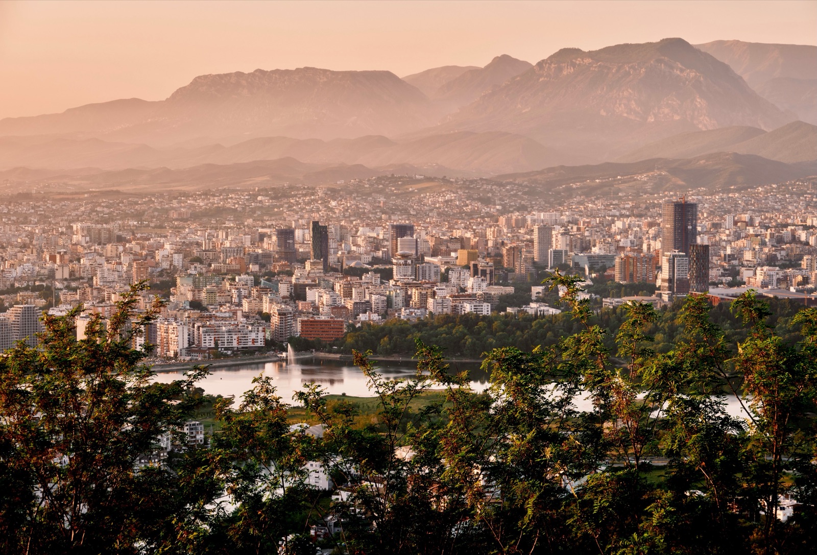 Panoramic view over Tirana with the mountains behind the city at sunset